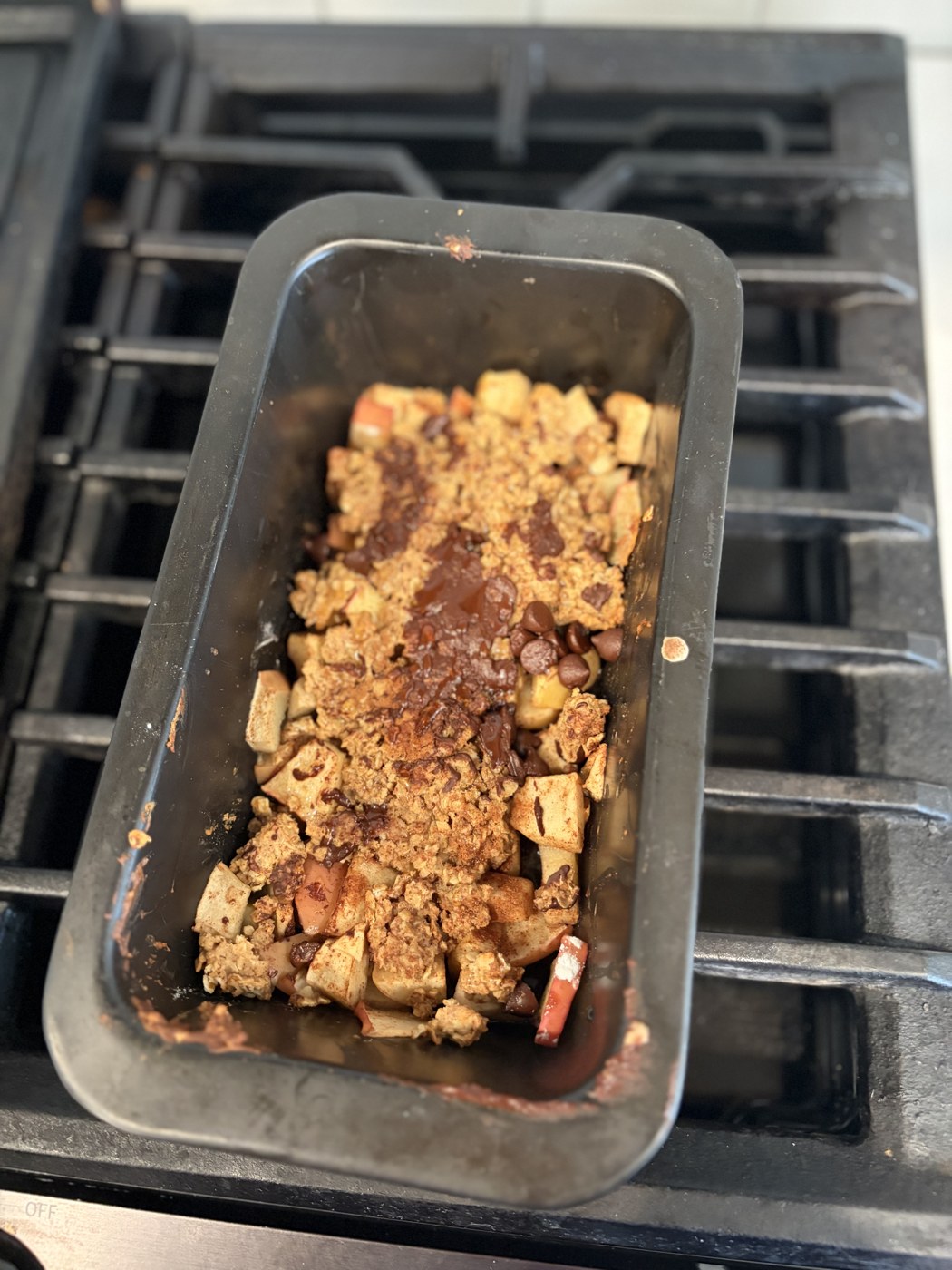 A homemade golden loaf in its baking tin